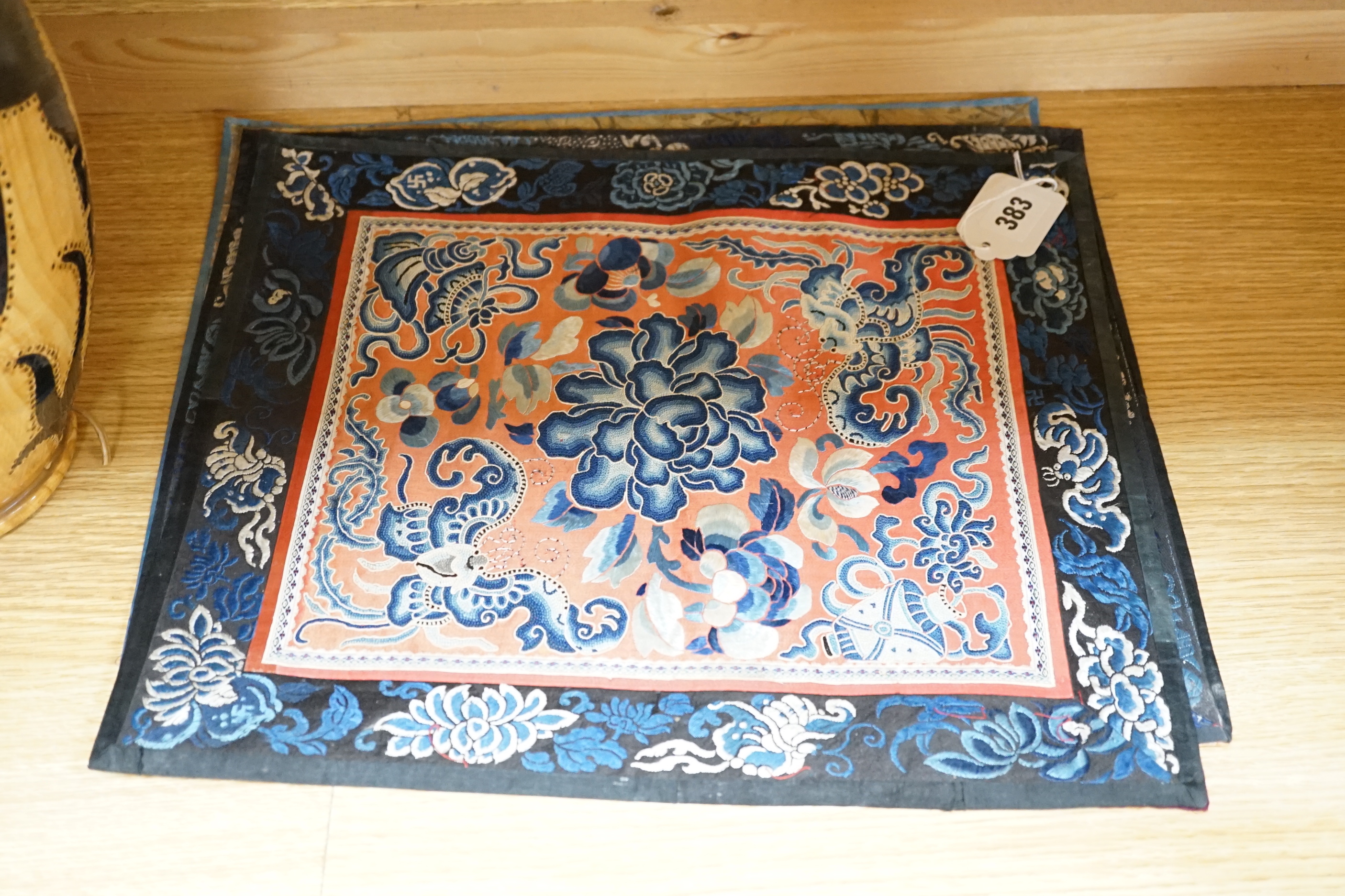 Six Chinese silk mats, embroidered with silk polychrome thread, all using mixed stitches including Beijing knot, five bordered with silk brocade, largest 43cm wide x 37cm high